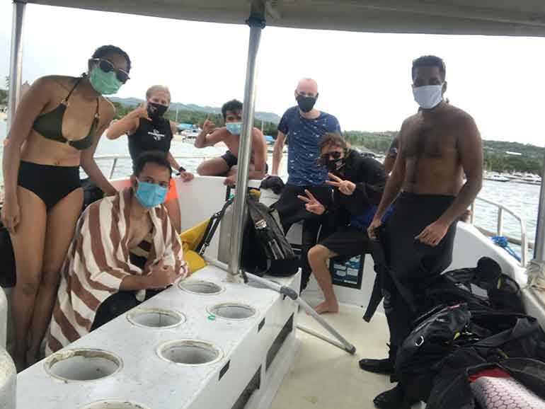 divers on boat social distancing